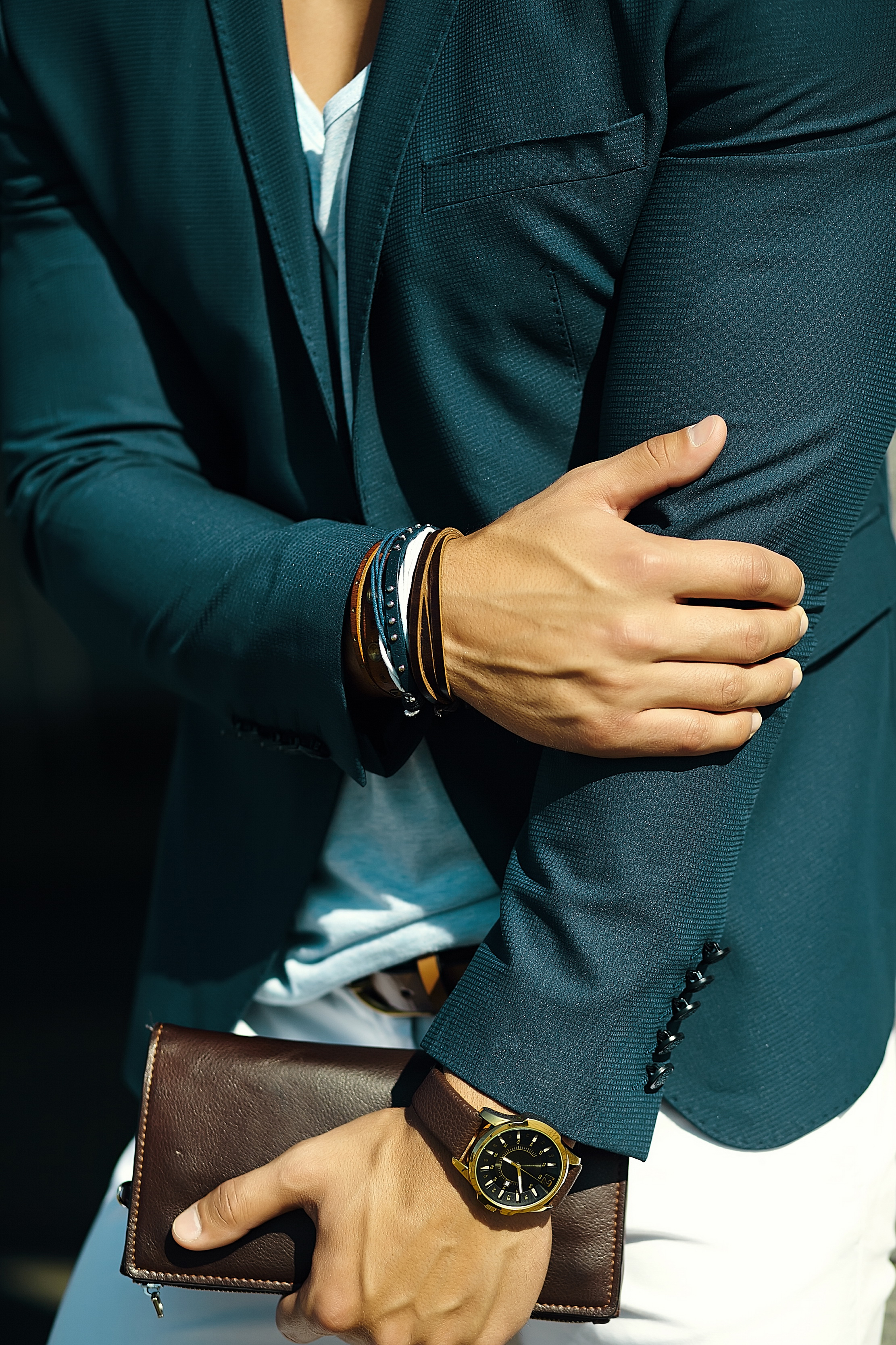 Fashion portrait of young businessman handsome model man in casual cloth suit with accessories on hands